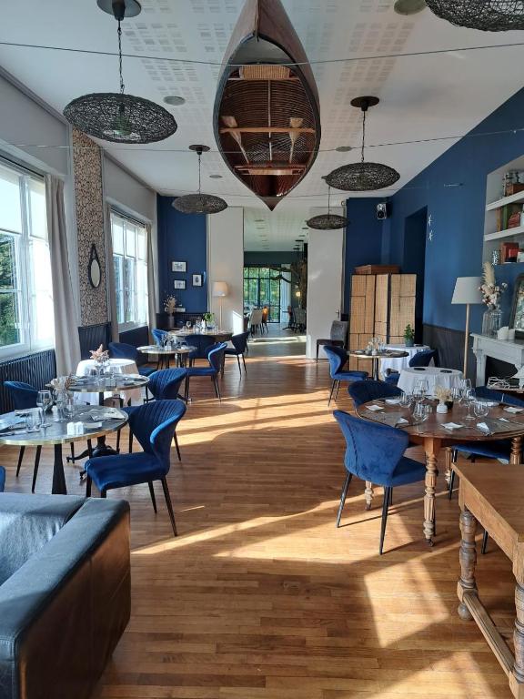 une salle à manger avec des tables et des chaises bleues dans l'établissement Hotel Restaurant Le Bosquet, à Les Ponts-de-Cé